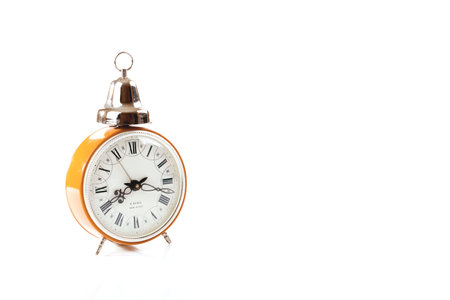 Vintage alarm clock isolated on white with \Made in USSR\ lettering on clock face.