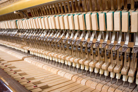 Action mechanics close up inside of an upright pianoの写真素材
