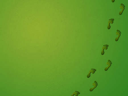 Grass footprints on a green background, relating to the environment. View close up for high detail.の写真素材