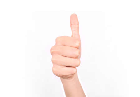 Female hand giving a thumbs up approval. Isolated on a white background.の写真素材