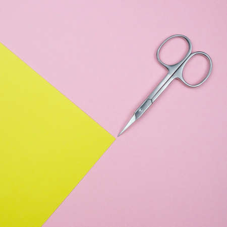 Square Composition With Manicure Scissors For Nails On The Geometric Pastel Pink And Yellow Colors Background Minimal Style Flat Lay Copy Spaceの写真素材
