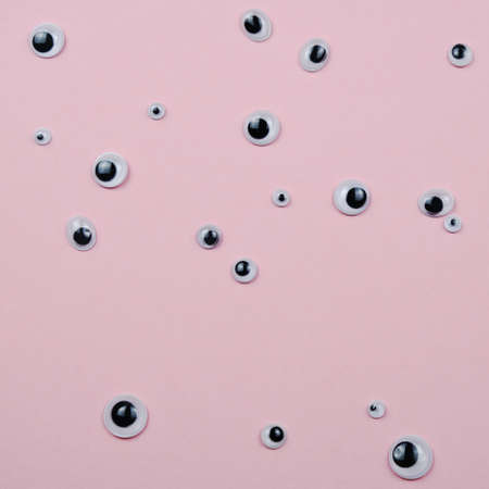 Abstract Pattern Many Plastic Toy Eyes On The Pink Pstel Background Flat Lay Creative Surrealの写真素材