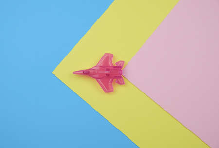 Flat lay Design Of Travel Concept With Plane On Pastel Blue, Yellow And Pink Background With Copy Space Minimal Styleの写真素材