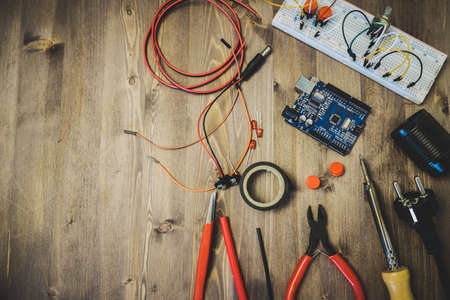 Workplace With Tools: Breadboard, Push Button, Resistors, Tweezers, Nippers, Soldering Iron, Wires, Microcircuit, Lamp Socket. Electronics Repair Service. Concept of Electronics, Programming.の写真素材