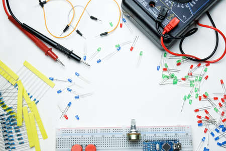 Multimeter, Red Green Blue Diodes, Resistors, Breadboard, Micro Circuits And Wires On The White Backgroundの写真素材
