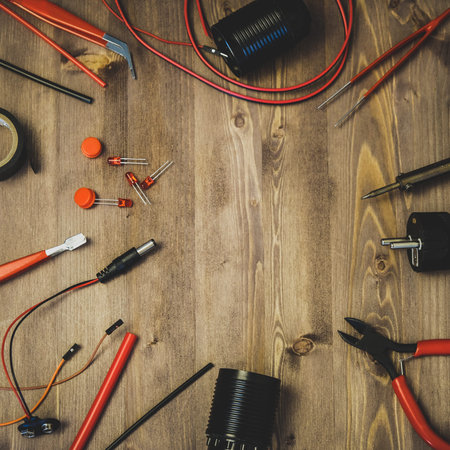 Workplace With Tools: Breadboard, Push Button, Resistors, Tweezers, Nippers, Soldering Iron, Wires,...