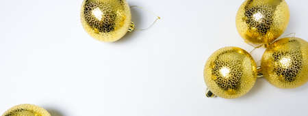 Christmas or New Year composition with golden balls on white background. Flat lay, top view, long banner with space for textの写真素材