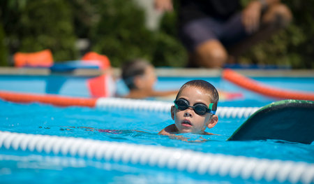 Contestant receives instructions from their coach while in the pool.