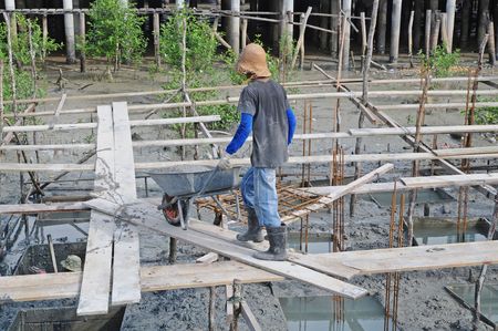 Worker Pushing Wheel Barrowの写真素材