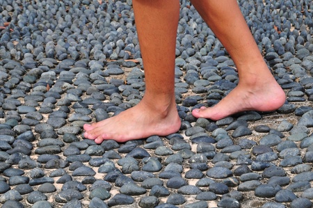 Walking Bare Footed On A Cobblestone Surfaceの写真素材