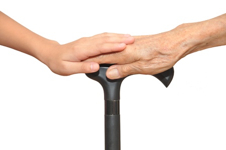 Old And Young Hands  Holding Onto A Walking Stickの写真素材