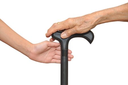 Old And Young Hands Holding Onto A Walking Stickの写真素材