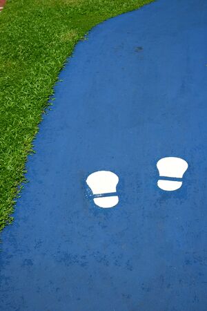White Foot Prints On Blue Walking Trackの写真素材