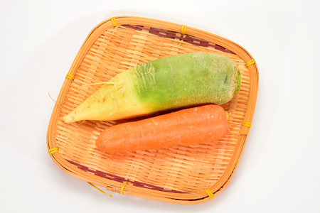 Radish And Carrot On Straw Trayの写真素材