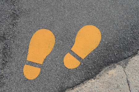 Yellow Footprints Symbol On A Walking Trackの写真素材
