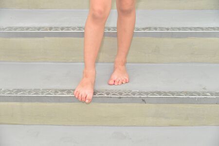Walking Bare Footed Down A Flight of Staircaseの写真素材