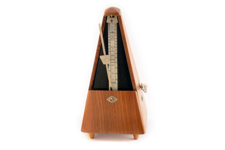 Old classic metronome isolated on white background