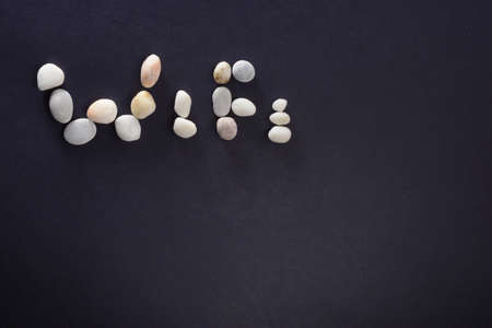 Word WiFi laid out of sea stones isolated on a dark background closeupの写真素材