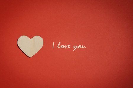 Love you concept. Wooden heart on red backgroundの写真素材
