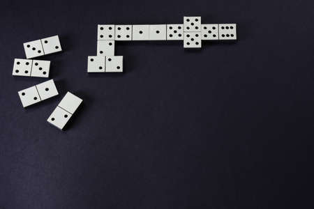 Dominoes board game on dark background closeup. Gambling conceptの写真素材