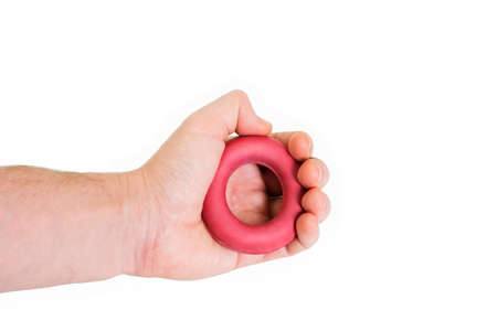 Expander rubber in hand ring trainer on white background. Gym sport equipment isolatedの写真素材