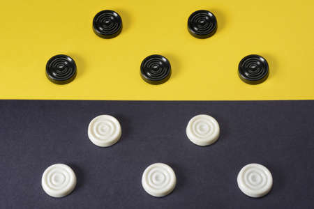 Checkers competition, rivalry. Closeup black and white figures. Sports conceptの写真素材