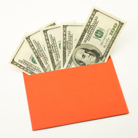 Money in red envelope. One hundred bills. Unofficial salary. Fan of dollars closeupの写真素材