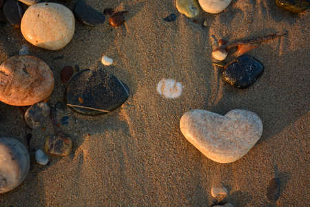 Heart of stone on the pebble beach. Love concept. Valentine backgroundの写真素材