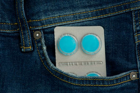 Pills in jeans pocket. Medical health conceptの写真素材