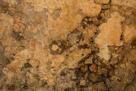 Grunge wall brown background. Abstract old texture with copy space for text or image. Vertical water spots on the vintage stone wall after rainの写真素材