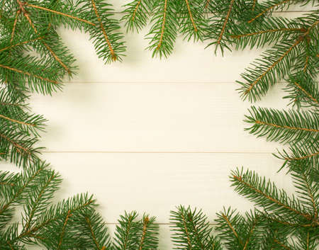 Christmas tree frame branches on wooden background with copy space. Horizontal template top view for designの写真素材