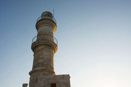 Lighthouse on sky background closeup in Venetian Harbor in Chania Old Town at sunny day. Crete island of Greeceの写真素材