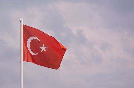 Turkish flag isolated on sky background moving in the wind. State symbol of Turkey