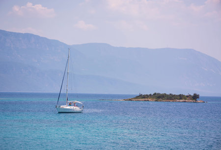 Aegean Islands and yacht on mountains and blue sky background, Turkey. Tropical wallpaper, paradise...