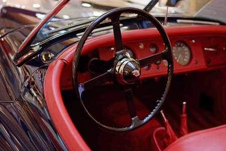 Moldova, Kishinev - May 22, 2019. Jaguar steering wheel of retro car closeup blurred background....