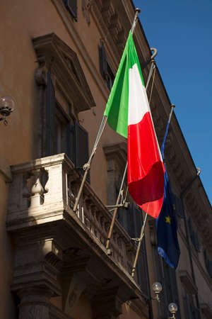 Flag of Italy and European Union on balcony of old building closeup at sunny dayの写真素材