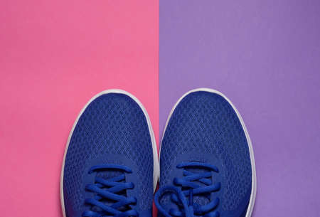 Sport sneakers on pink purple background with copy space for text. Sport objects background. Sports conceptの写真素材