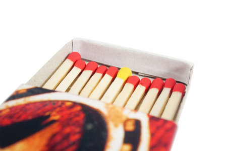 Matchbox with red and yellow matches isolated over white background