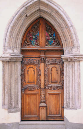 Old style brown wooden door with sculpturesの写真素材