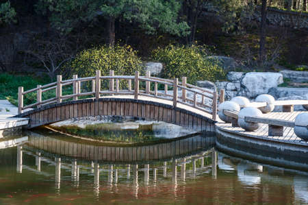 The small bridge over a pond in springの写真素材