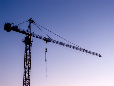 A crane against blue sky in the dawn