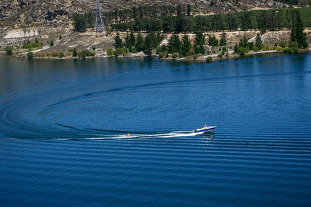 A speed boat is running in the lake