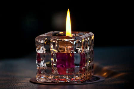 Burning candle in the glass container の写真素材