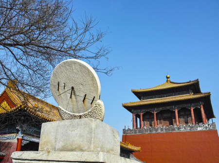Ancient Chinese sundial, the background building is Forbidden Cityの写真素材