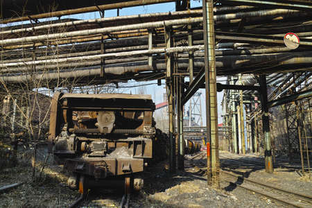 Rusted rail vehicle in abandoned steel worksの写真素材