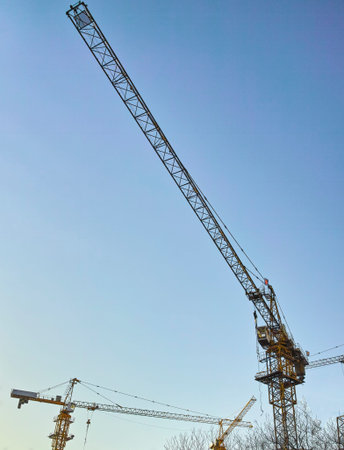 Cranes against blue sky