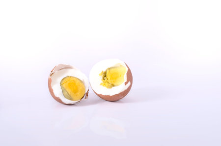 One boiled split egg on the white background