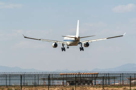 A plane is landing on the airportの写真素材