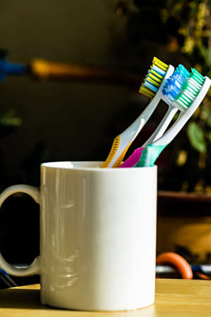 Three Toothbrushes on a cupの写真素材