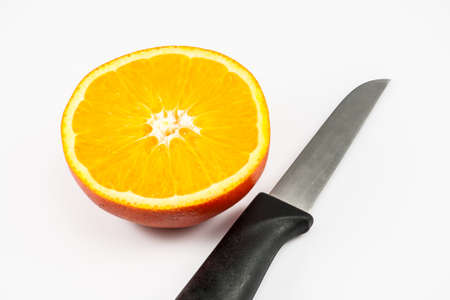 Orange and a knife on the white backgroundの写真素材